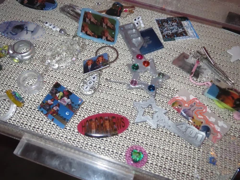 A drawer filled with 401 star jewelry, colorful charms, and keepsakes